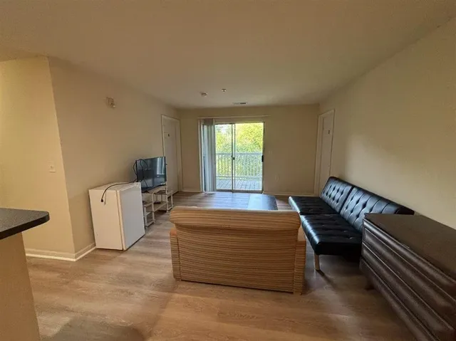 a view of livingroom with couch and wooden floor