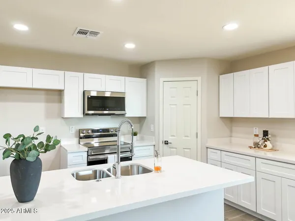 a kitchen with a sink a stove and cabinets