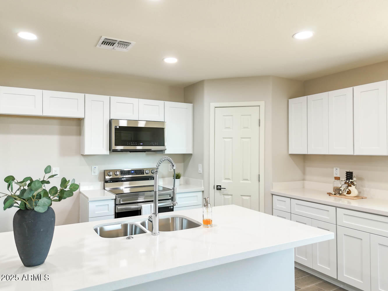 a kitchen with a sink a stove and cabinets