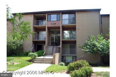 8013 Mandan Road, Unit 304 Greenbelt, MD 20770 - Photo 1 of 12 a front view of a house with a yard