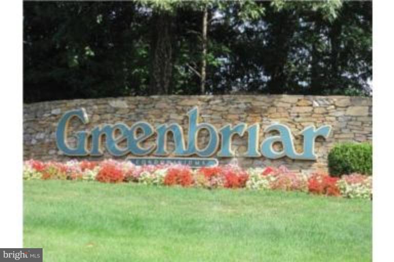 8013 Mandan Road, Unit 304 Greenbelt, MD 20770 - Photo 2 of 12 a street sign that is sitting in the grass