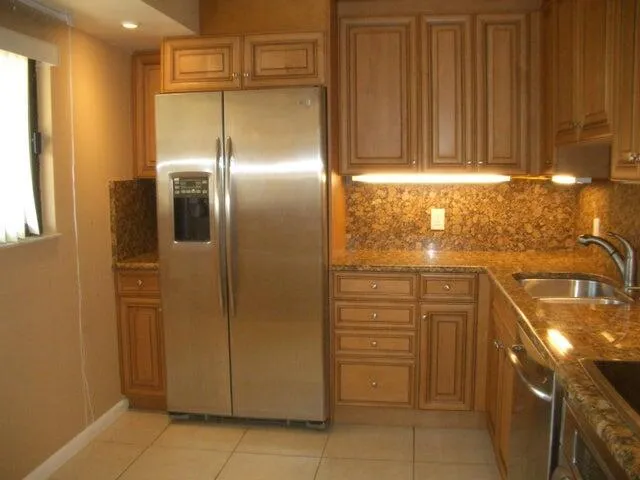 a view of a refrigerator in kitchen