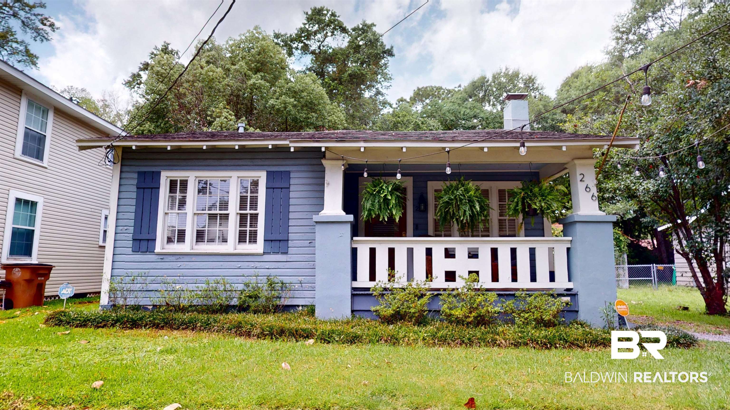 266 Westwood Street Mobile, AL 36606 - Photo 1 of 34 View of front of house with covered porch, a front lawn, and a chimney