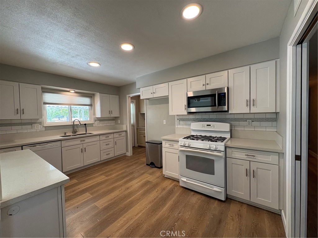 26378 Ridgemoor Road Menifee, CA 92586 - Photo 5 of 20 a kitchen with stove a sink and microwave