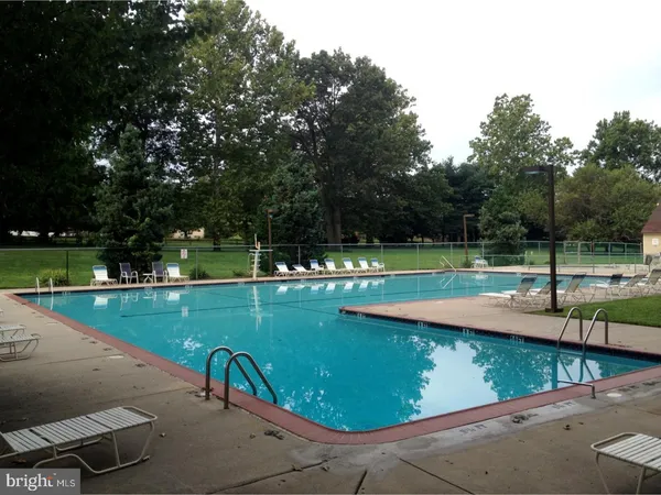 a view of a swimming pool with a yard
