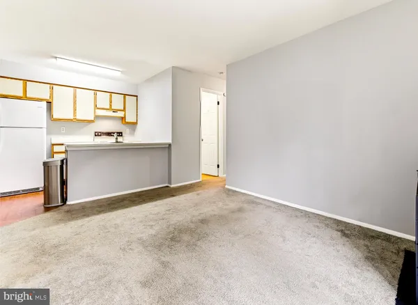 a view of kitchen with wooden floor and electronic appliances