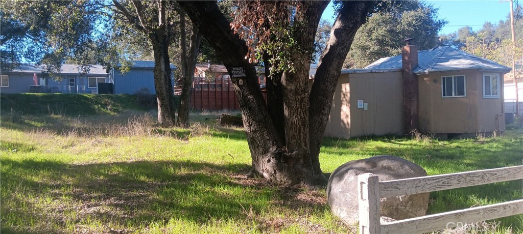 18635 Keyes Drive Banning, CA 92220 - Photo 4 of 6 a backyard of a house with lots of green space and fountain