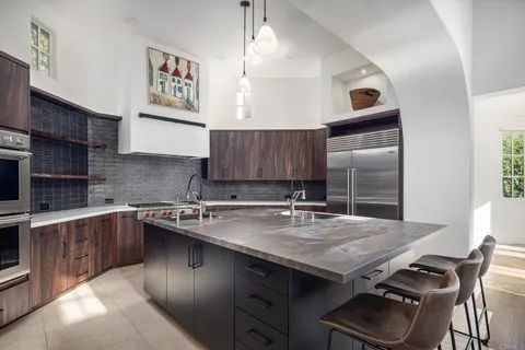 a kitchen with a stove a sink and a refrigerator