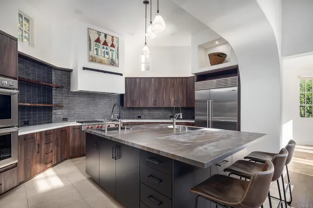 a kitchen with a stove a sink and a refrigerator