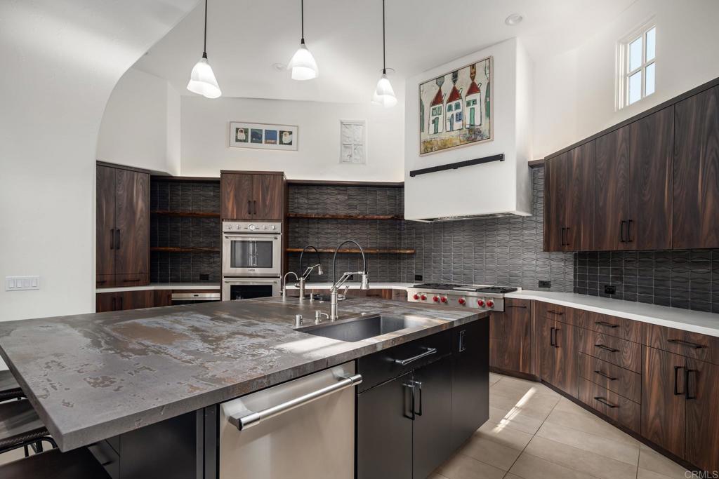 18596 Corte Fresco Rancho Santa Fe, CA 92091 - Photo 14 of 41 a kitchen with stainless steel appliances granite countertop a sink stove and cabinets