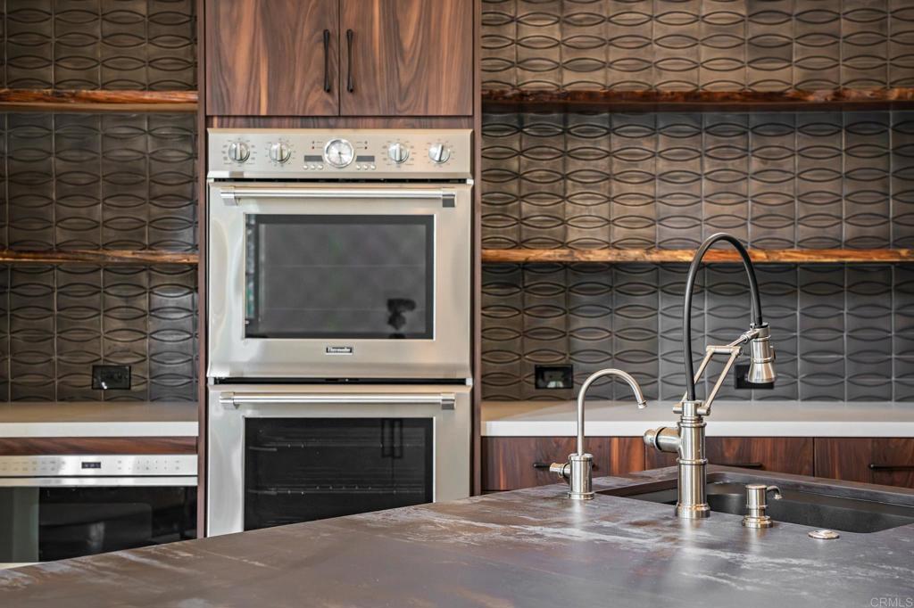 18596 Corte Fresco Rancho Santa Fe, CA 92091 - Photo 15 of 41 a stove top oven sitting inside of a kitchen