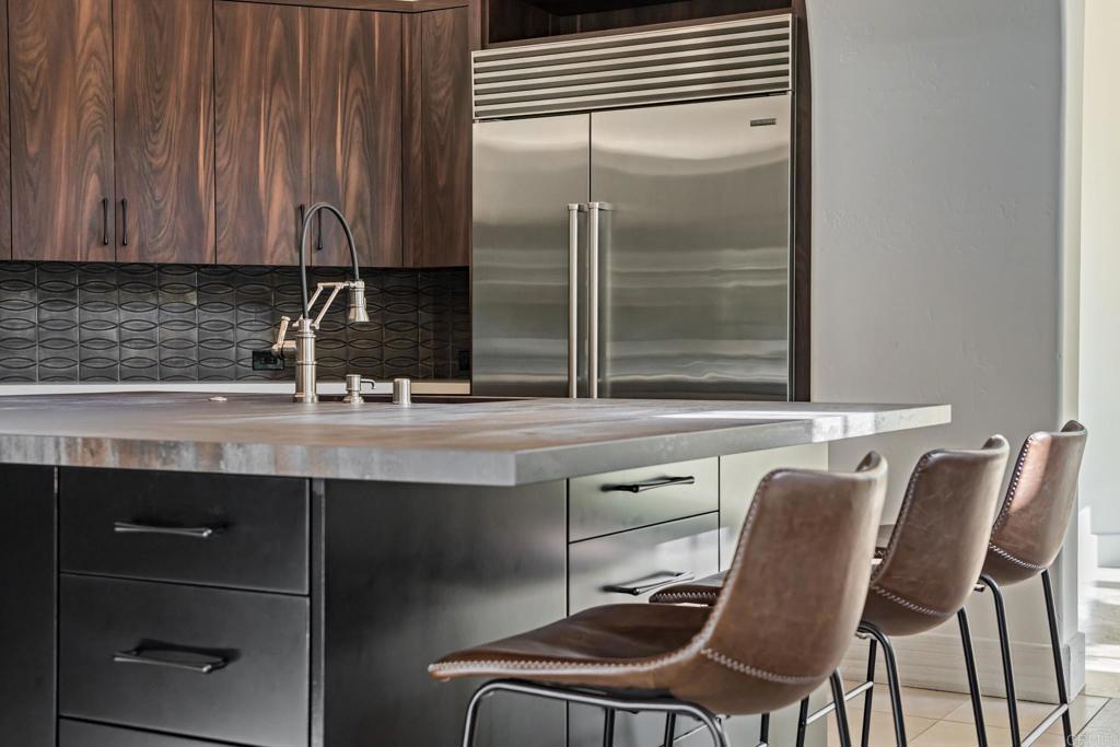 18596 Corte Fresco Rancho Santa Fe, CA 92091 - Photo 16 of 41 a kitchen with a table chairs cabinets and appliances