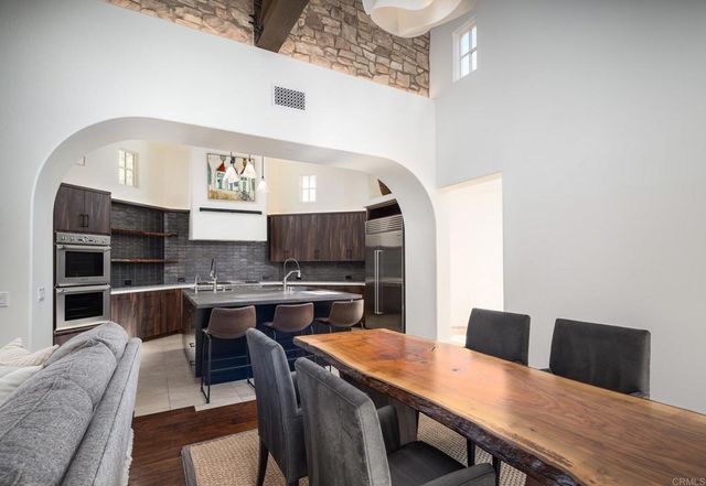 a large kitchen with a table and chairs in it