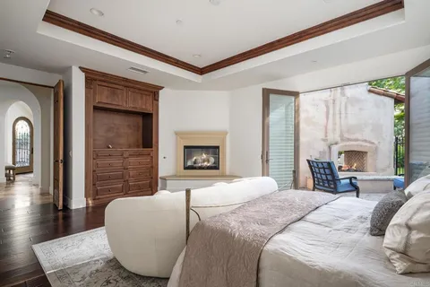 a bedroom with a bed and a fireplace