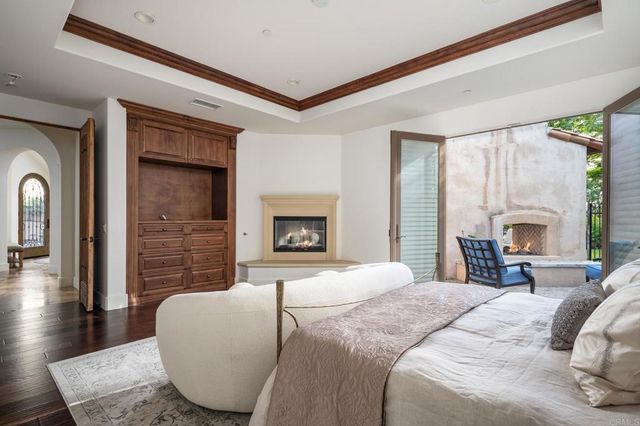 a bedroom with a bed and a fireplace