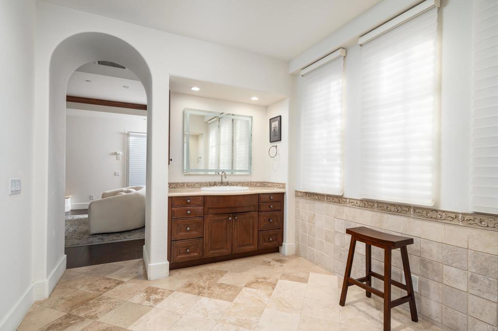 18596 Corte Fresco Rancho Santa Fe, CA 92091 - Photo 27 of 41 a spacious bathroom with a granite countertop sink a mirror and a bathtub