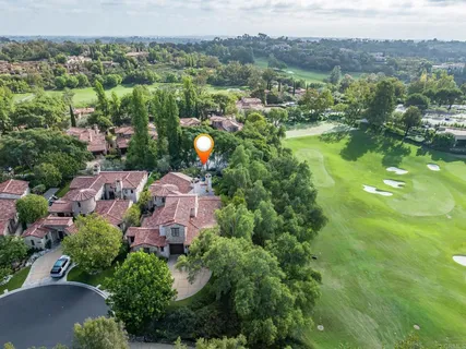 an aerial view of house with yard swimming pool and mountains
