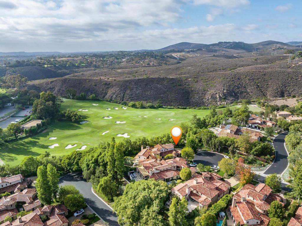18596 Corte Fresco Rancho Santa Fe, CA 92091 - Photo 40 of 41 a view of a lush green hillside and houses