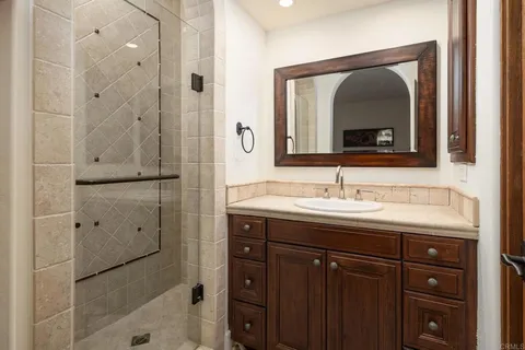 a bathroom with a granite countertop sink mirror and double