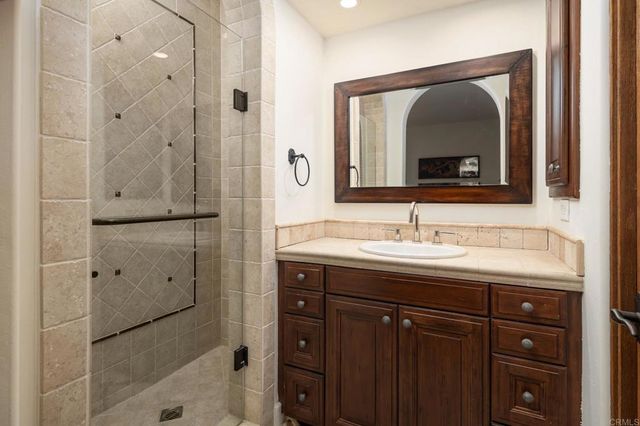 a bathroom with a granite countertop sink mirror and double