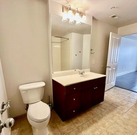 230 East Ponce De Leon Avenue, Unit 409 Decatur, GA 30030 - Photo 4 of 5 a bathroom with a sink vanity mirror and toilet