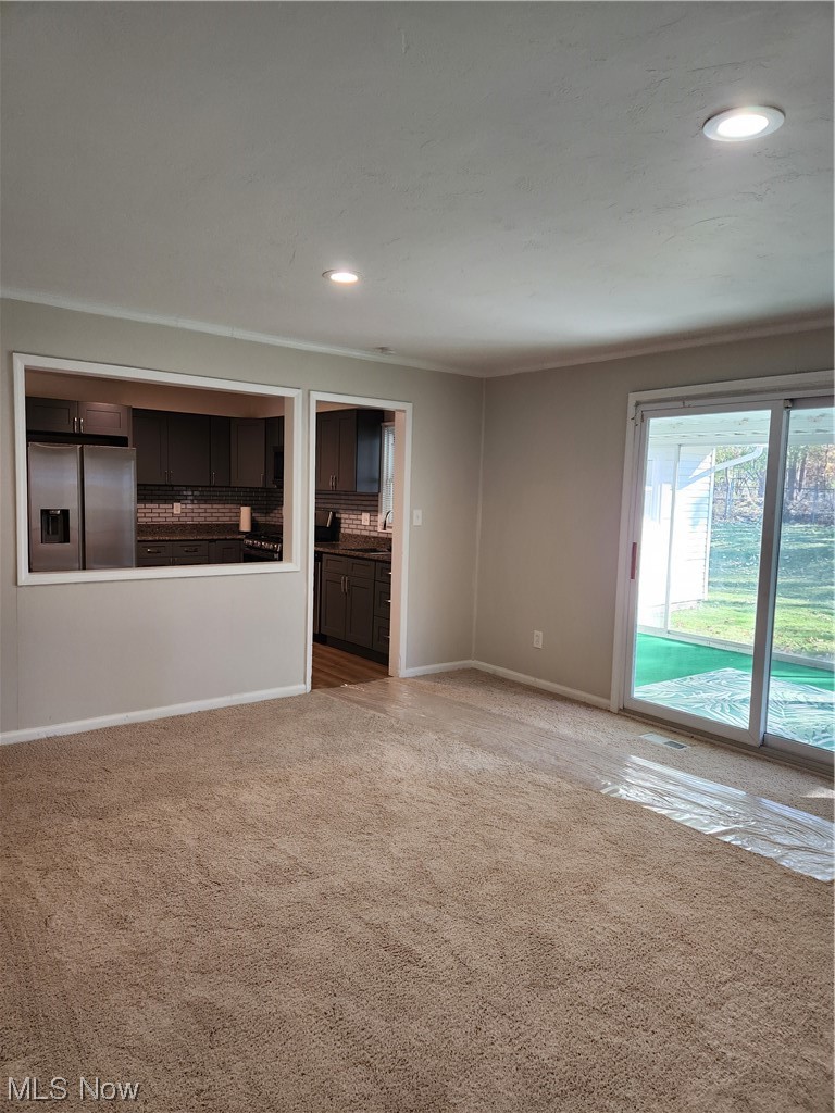 4660 West Farnhurst Road South Euclid, OH 44121 - Photo 8 of 17 Unfurnished living room with ornamental molding and light carpet