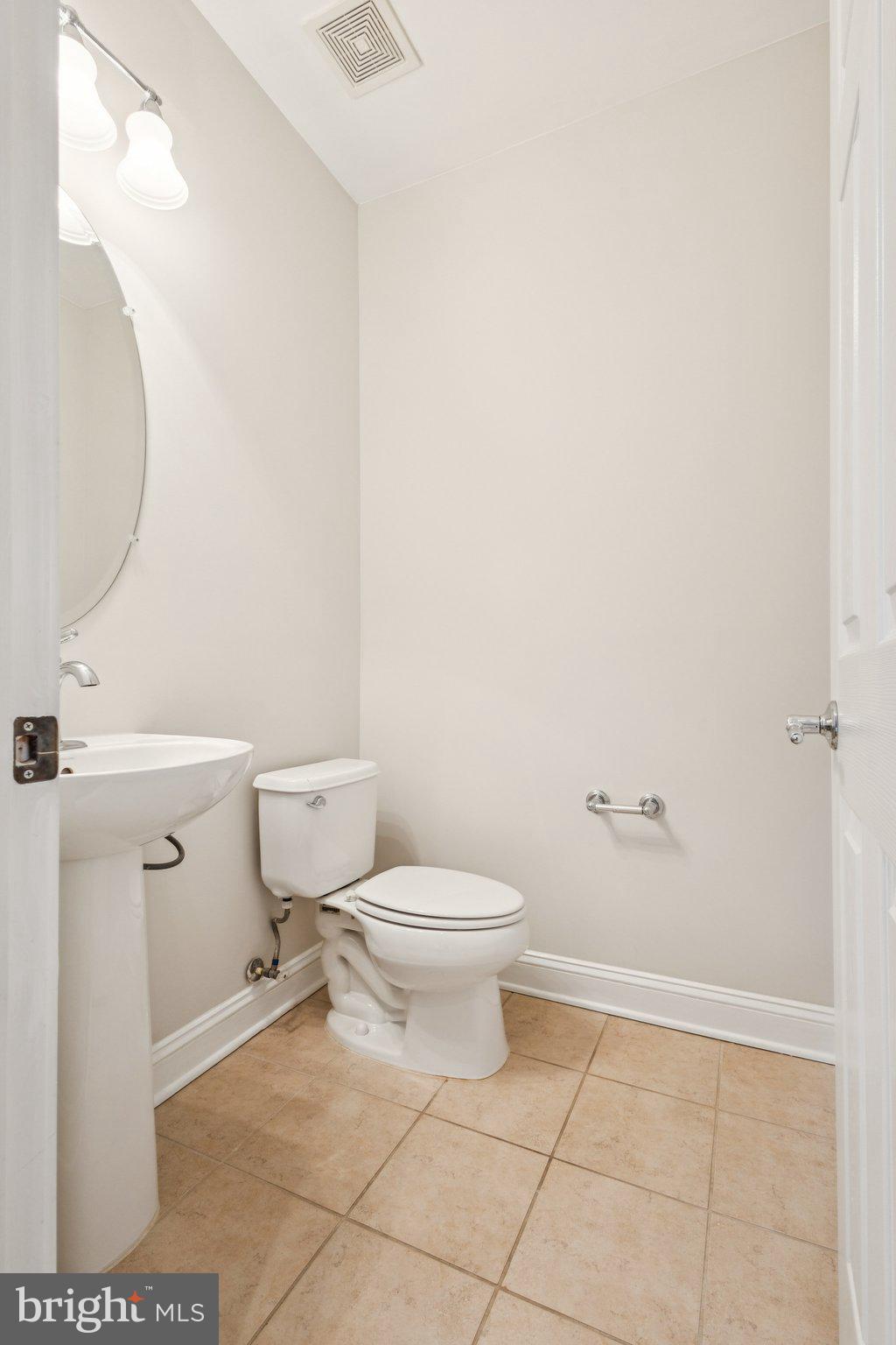 42761 Hay Road Ashburn, VA 20147 - Photo 11 of 46 a bathroom with a toilet and a mirror