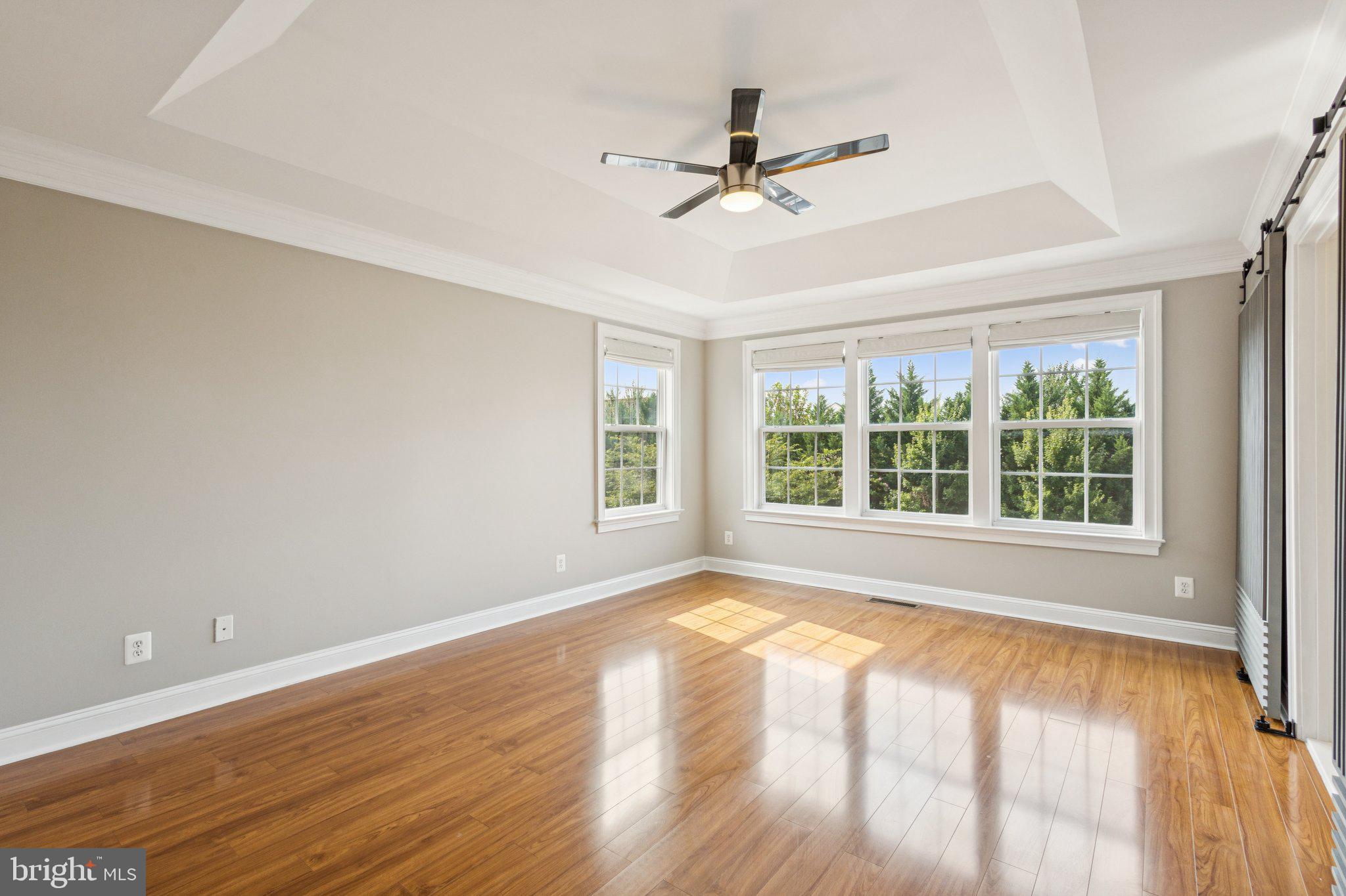 42761 Hay Road Ashburn, VA 20147 - Photo 13 of 46 a view of an empty room with a window and wooden floor