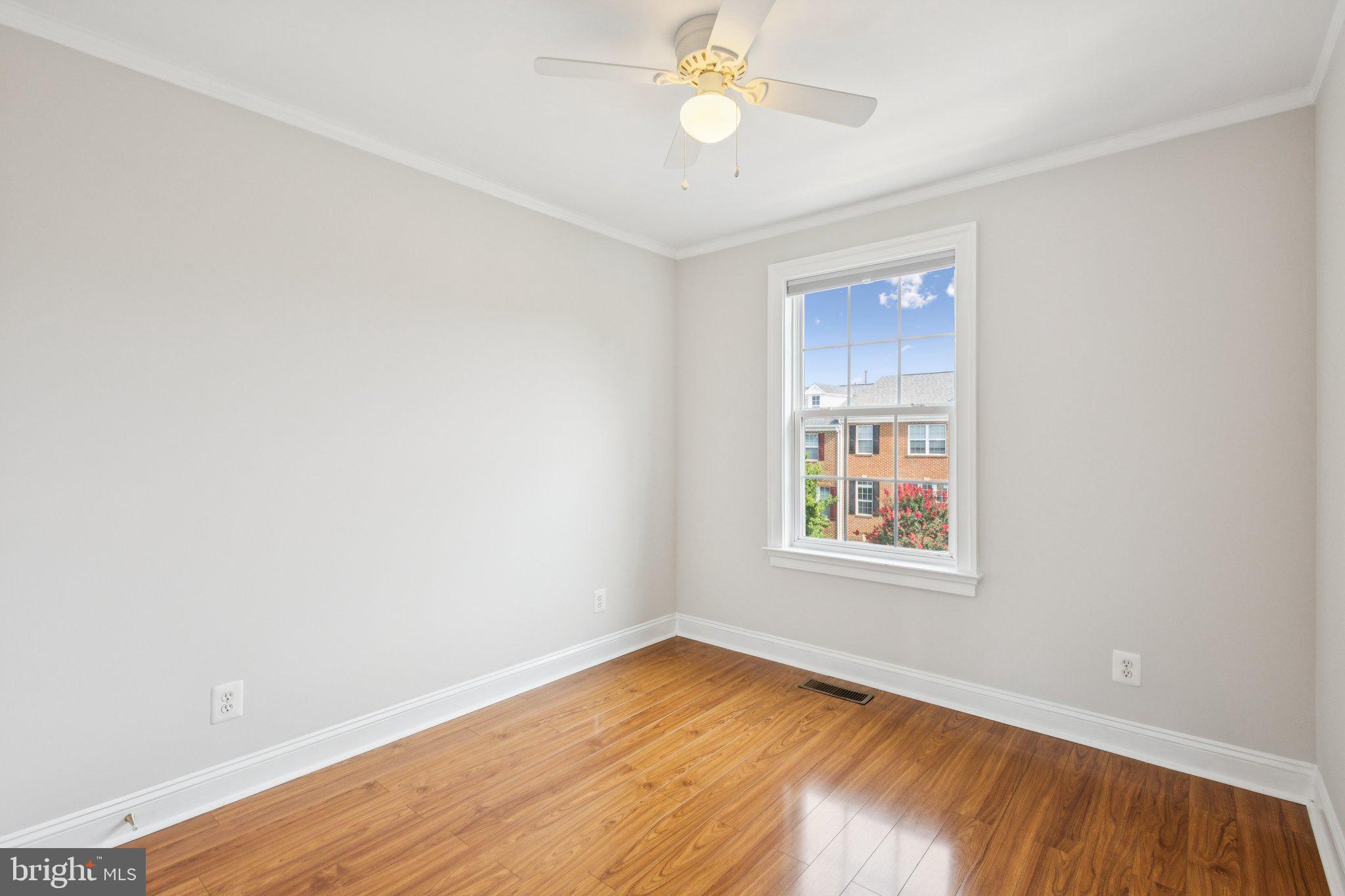 42761 Hay Road Ashburn, VA 20147 - Photo 16 of 46 a view of an empty room with wooden floor and a window