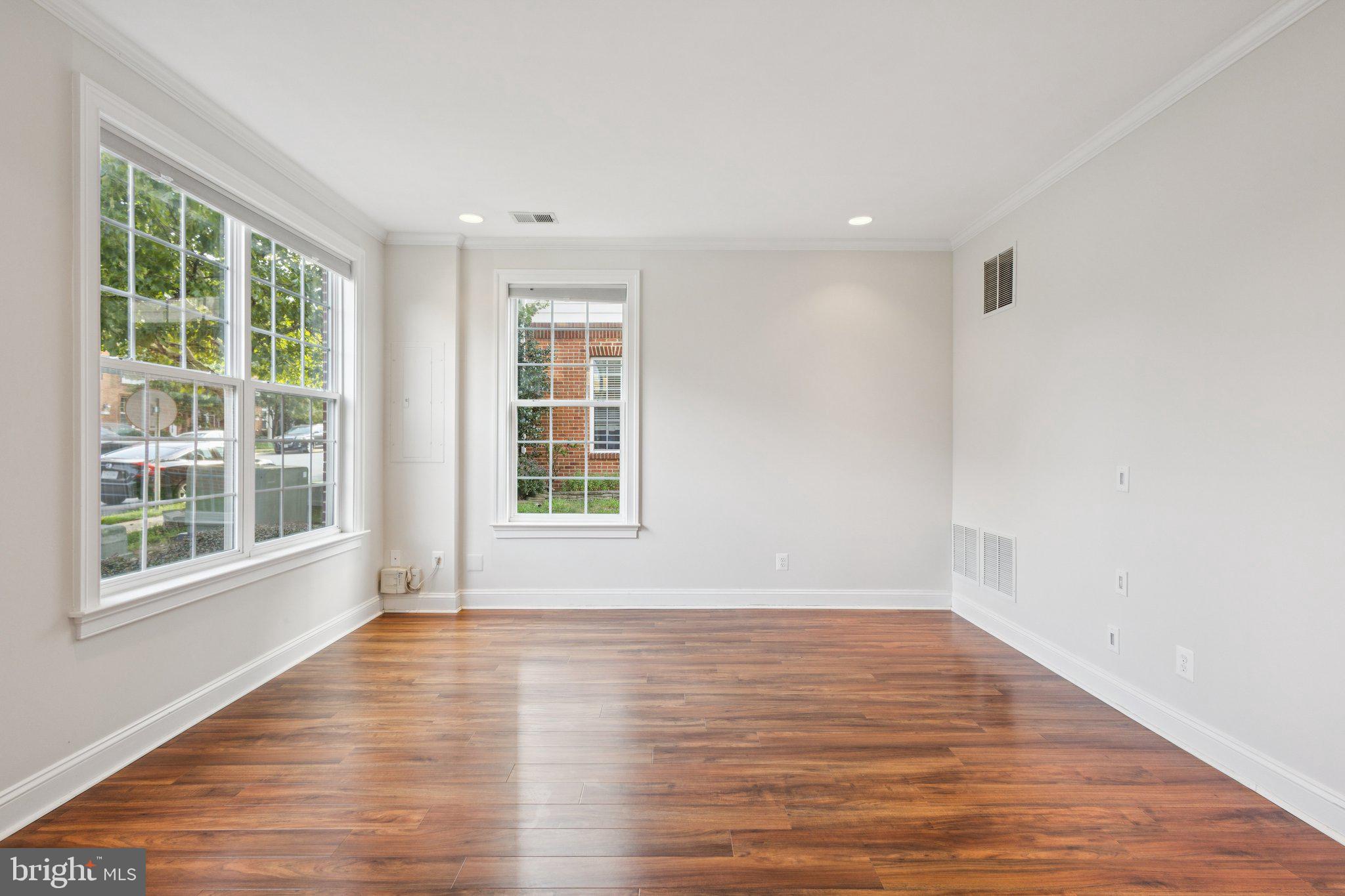 42761 Hay Road Ashburn, VA 20147 - Photo 4 of 46 a view of an empty room with wooden floor and a window