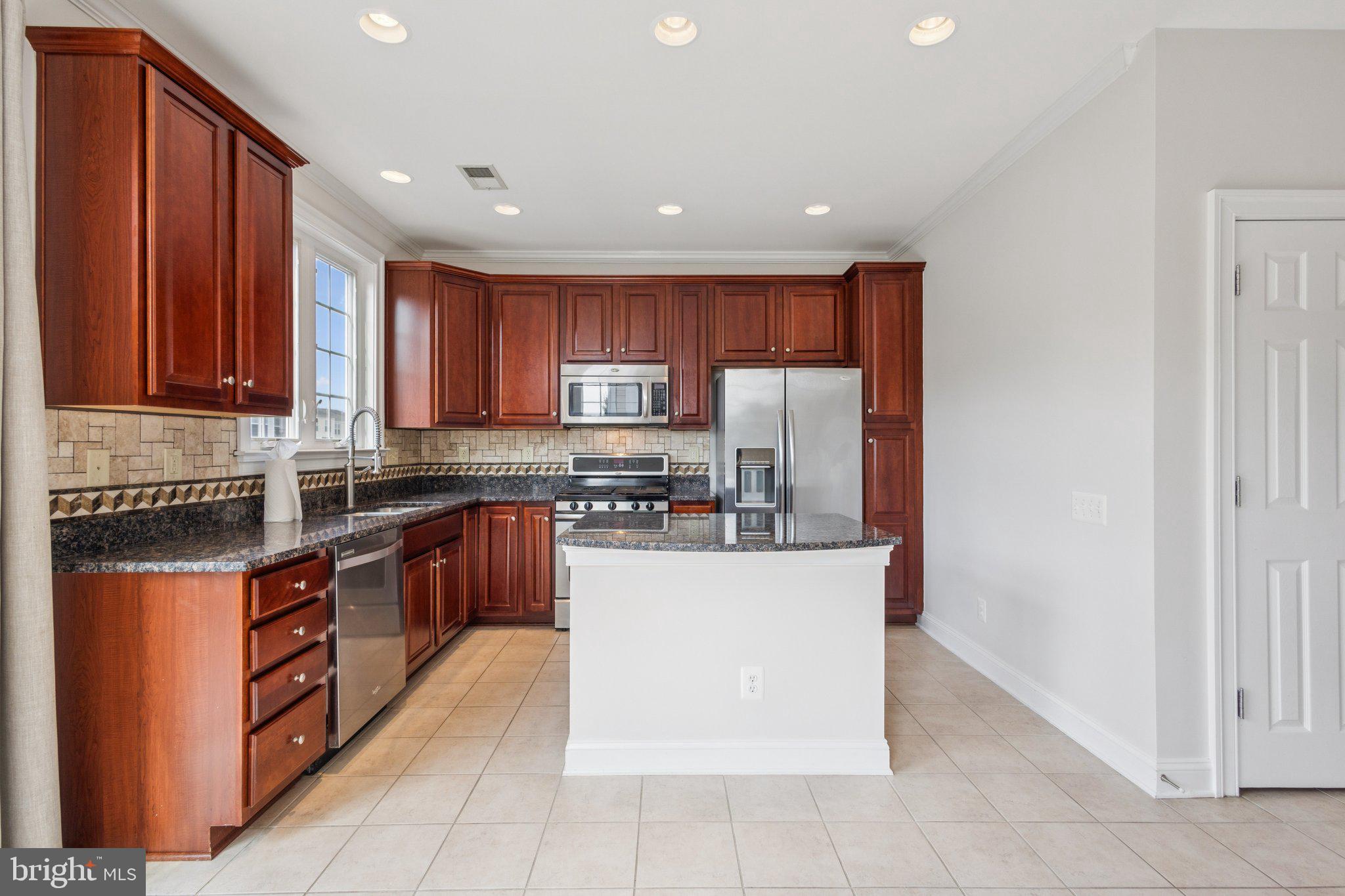 42761 Hay Road Ashburn, VA 20147 - Photo 9 of 46 a kitchen with stainless steel appliances granite countertop a refrigerator and a stove top oven
