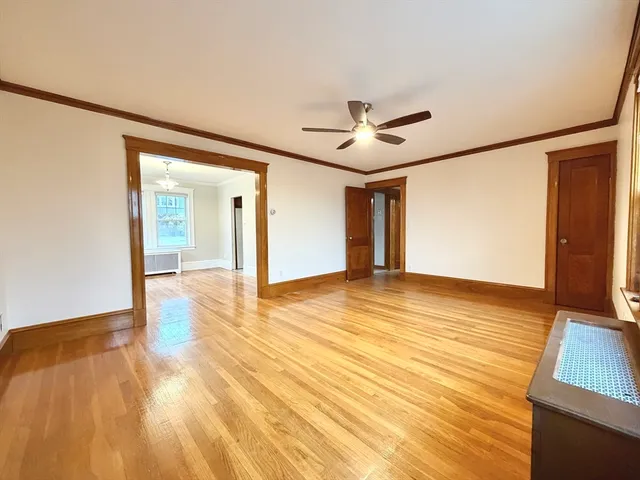 a view of an empty room with wooden floor