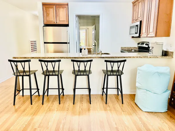 a dining room with furniture and a floor to ceiling window