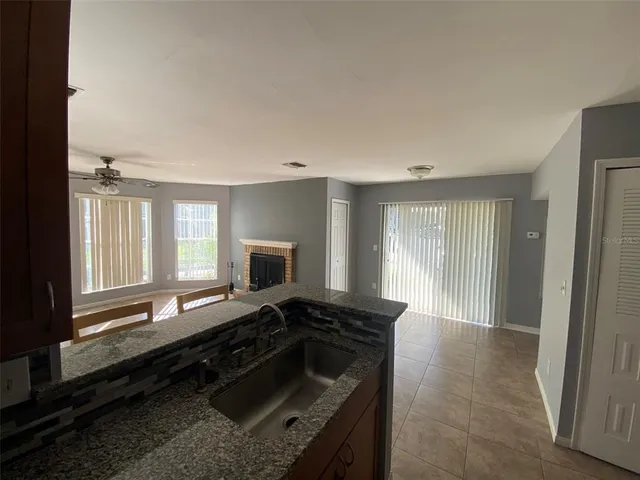 a kitchen with granite countertop a stove and a sink