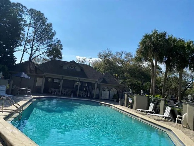 a view of a house with a yard patio and fire pit