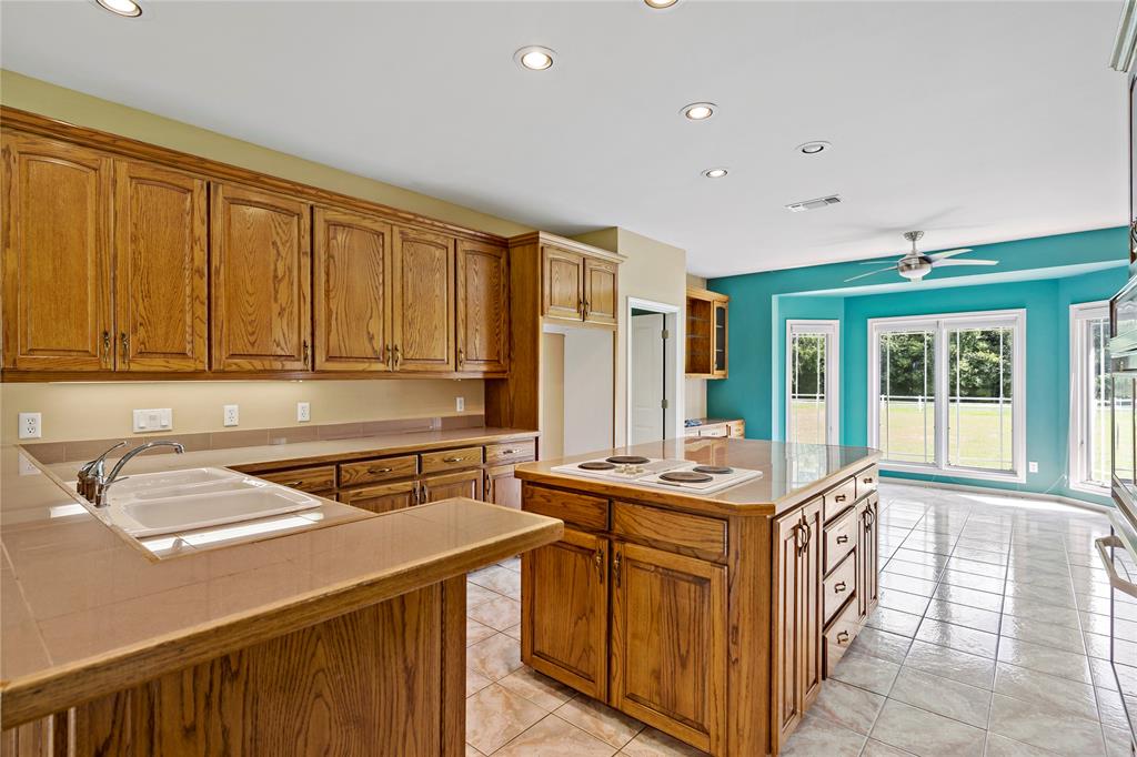 4905 Trails End Road Paris, TX 75462 - Photo 11 of 33 a kitchen with a sink stove and cabinets