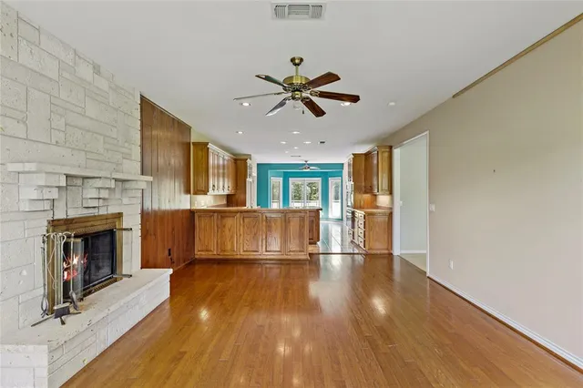 a view of a livingroom with a fireplace and a ceiling fan