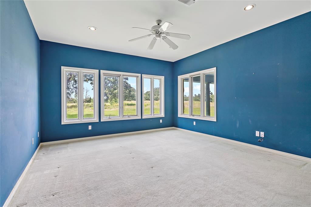 4905 Trails End Road Paris, TX 75462 - Photo 17 of 33 a view of an empty room with a window and a ceiling fan