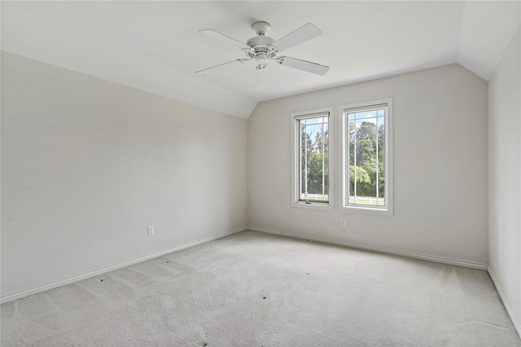 4905 Trails End Road Paris, TX 75462 - Photo 21 of 33 an empty room with a window and a ceiling fan