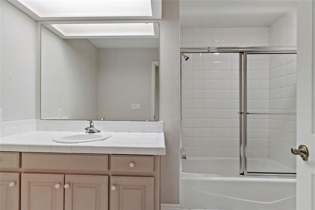 4905 Trails End Road Paris, TX 75462 - Photo 22 of 33 a bathroom with a sink vanity tub and shower