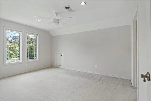 an empty room with windows and closet