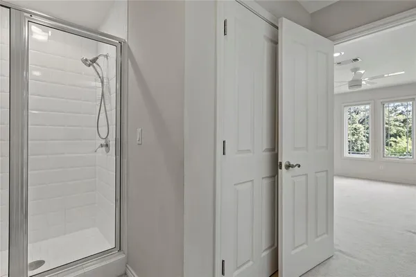 a bathroom with a glass shower door