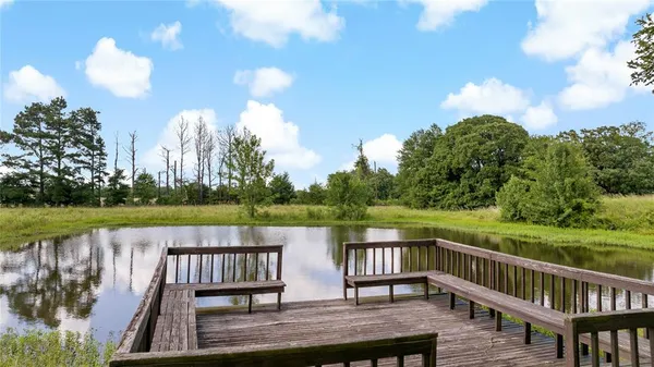 a view of a deck with hardwood floor and lake view