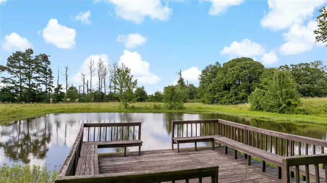 a view of a deck with hardwood floor and lake view