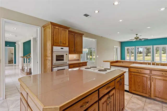 a kitchen with a stove a sink and a refrigerator