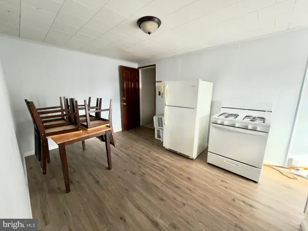 a view of kitchen with furniture and wooden floor