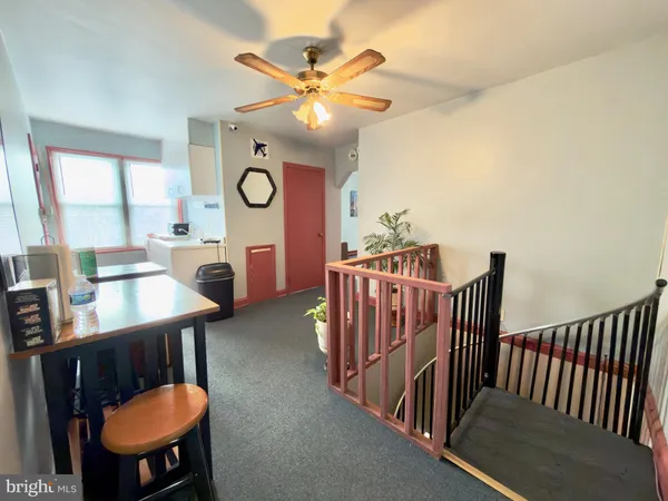 a view of a dining room and hall with furniture