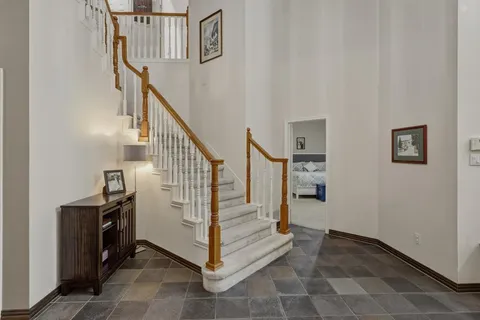 a view of a workspace with furniture and floor to ceiling window