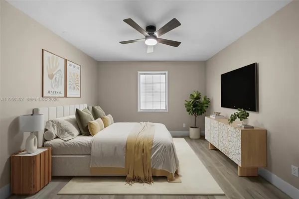 a bedroom with a bed and a flat screen tv