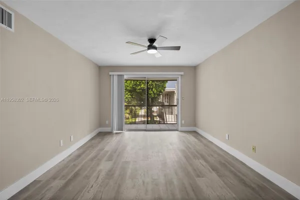 wooden floor in an empty room with a window